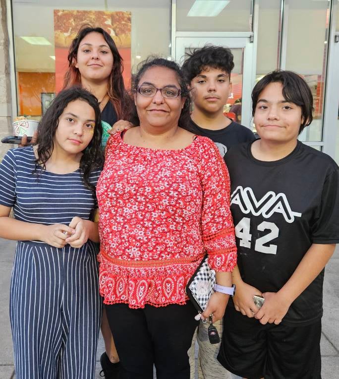 WGU graduate and MindEdge Scholarship recipient Laura Z. posing with her four children.