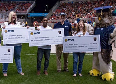 Sage the Owl posing with several WGU scholarship award recipients