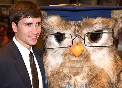 Sage the Owl mascot posing with someone