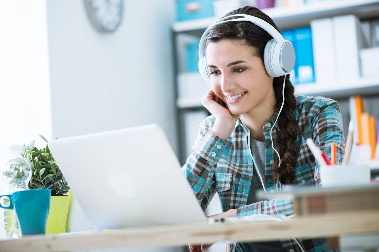 Woman using headphones to talk to student community