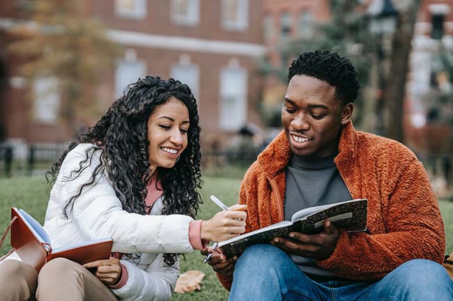 two students studying outside