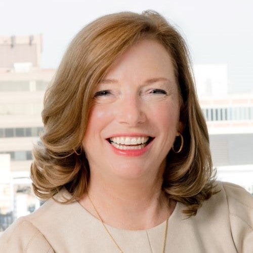 Barbara Humpton, CEO of Siemens Corporation, is a white woman with long red hair. She is smiling for the photo.