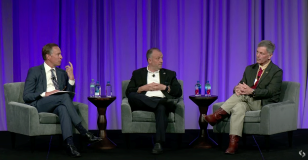 Photo of WGU President Scott Pulsipher, Hawaii Governor Josh Green, and Wyoming Governor Mark Gordon sitting in chairs and speaking to each other on stage.