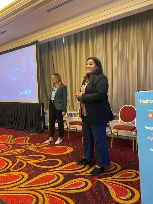 Margaret Simonis, left, and Malena Johnson, right, present in a conference room at the Hashtag Higher Ed event.