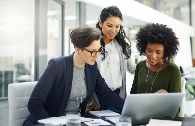 3 women looking at a computer