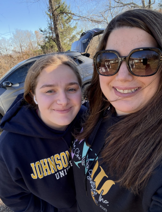 Sarah Larivee-Winslow and her daughter take a photo while volunteering together