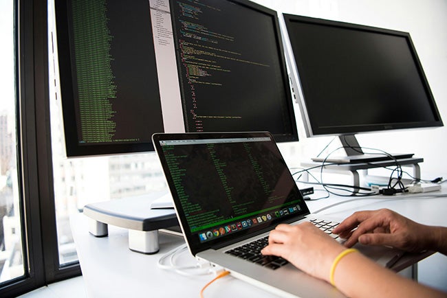 Embedded softare engineer a person reading code on their computer screen