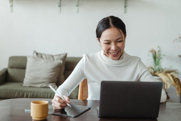 happy woman working at a laptop