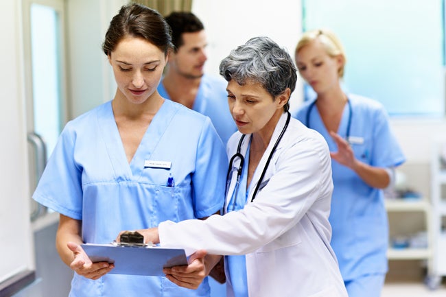 Two medical professionals reviewing a document