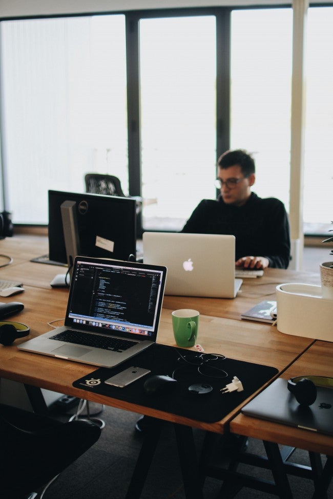 Man sitting at desk with laptop