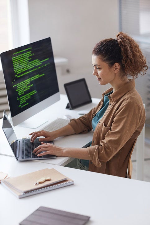 Young female IT professional using a laptop