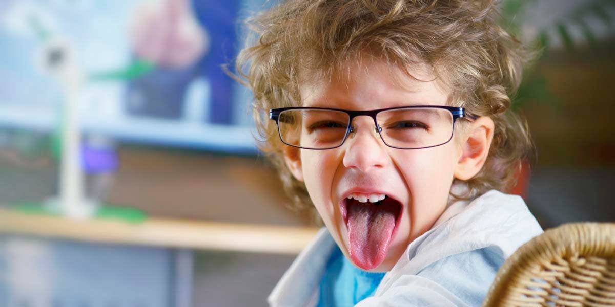 A young boy sticks his tongue out.