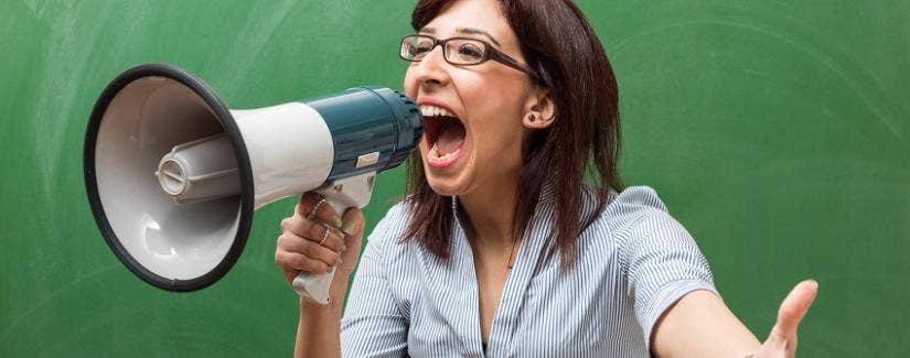 Teacher yells into a megaphone because she has lost control of her class.