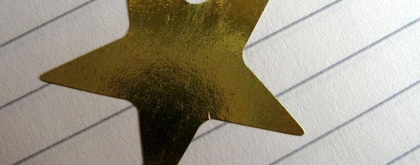Gold star on piece of paper