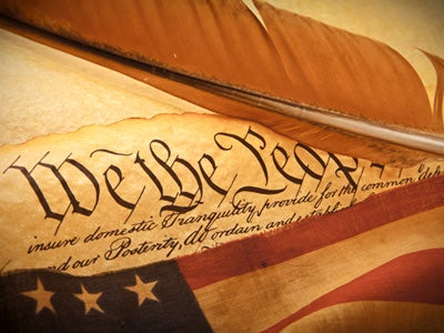Constitution with feather and partial flag