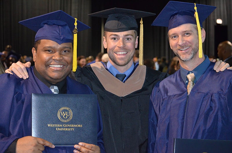 3 smiling people graduation