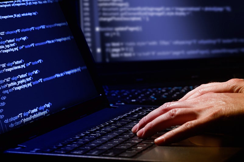 Hacker working with code