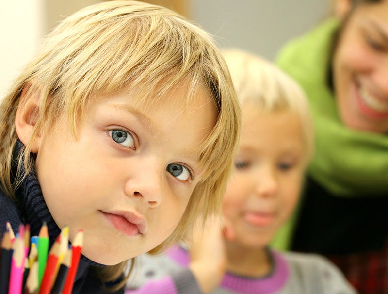 Kid in class looking right at camera