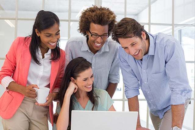 People crowded around laptop