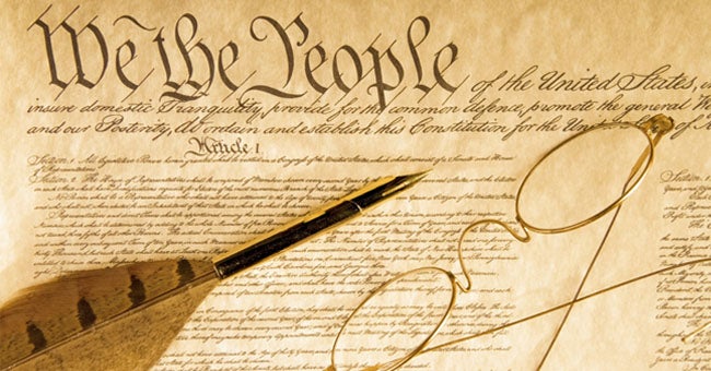 Constitution with feather and glasses