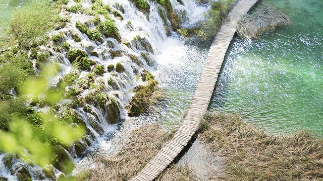 Waterfall over bridge.