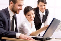 Co-workers looking at a laptop together