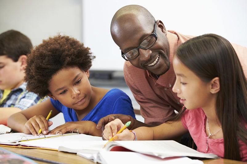 Teacher working with students