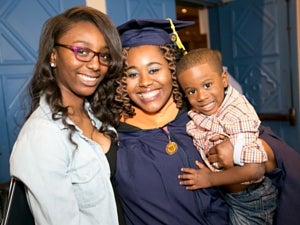 female graduate with her sister and baby