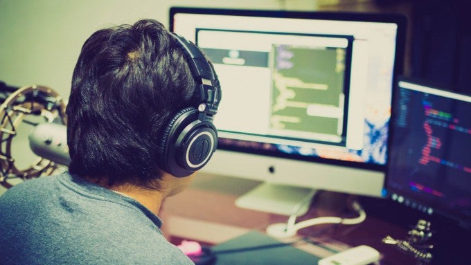 IT manager working with headphones on