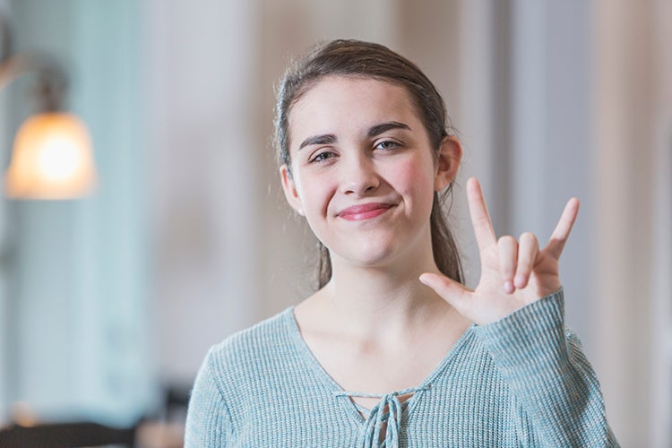 girl says love in sign language