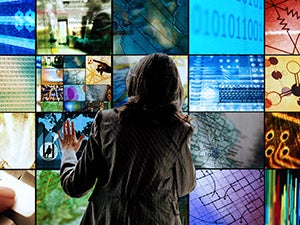 Person standing infront of a bunch of screens