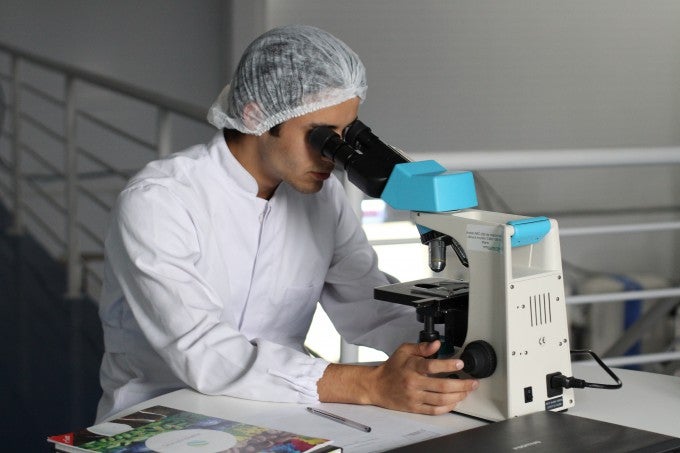 Looking at microscope for medical biotechnology
