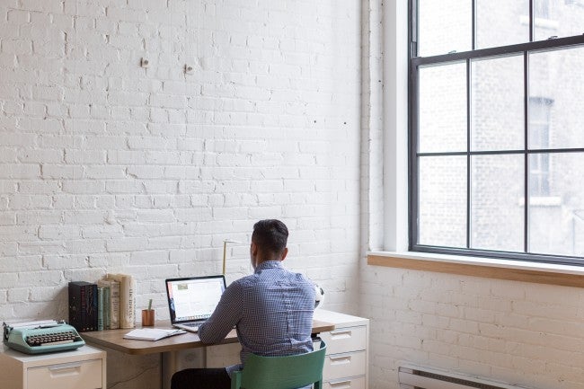 Man sitting at desk alone | startup