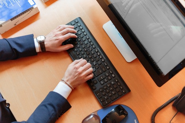 Hands typing on keyboard | password