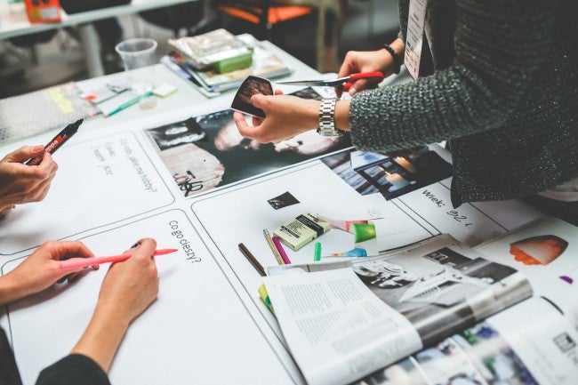 Group gathered around table doing marketing