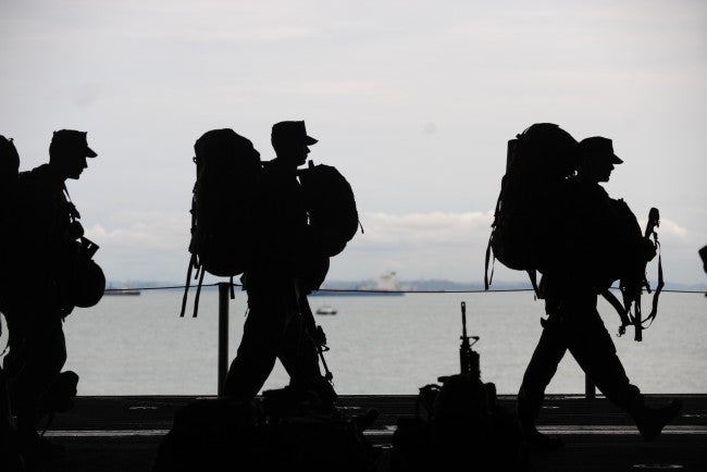 Silhouette of soldiers with packs on