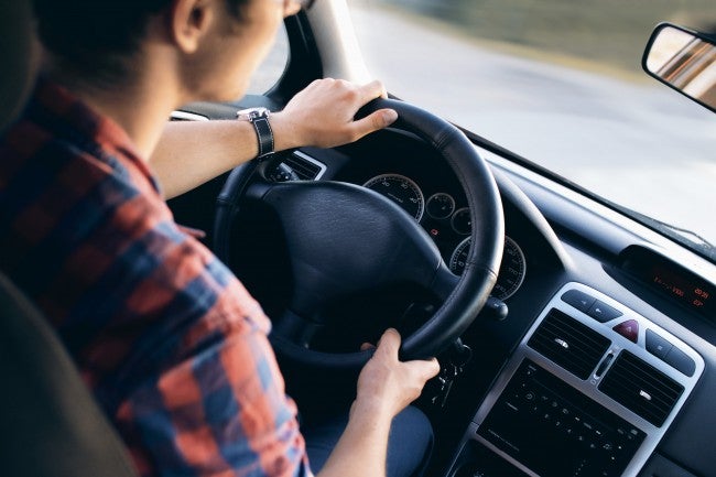 Person behind steering wheel | gig economy driver