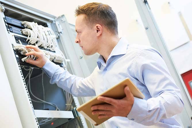 Networking service. network engineer administrator checking server hardware equipment of data center.