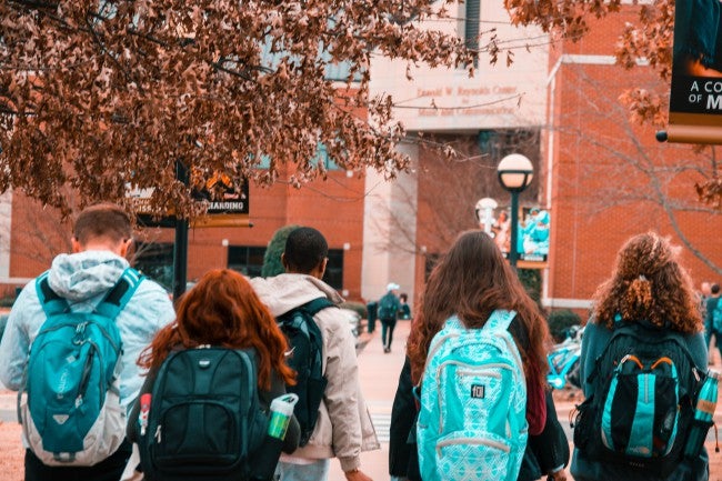 Men and women walking to college