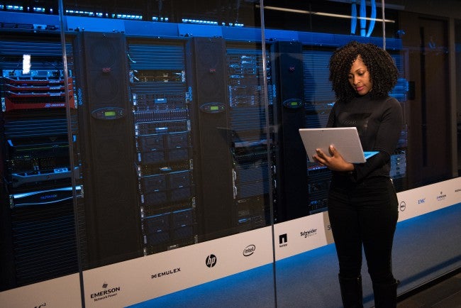 Woman in front of large system | software development degree