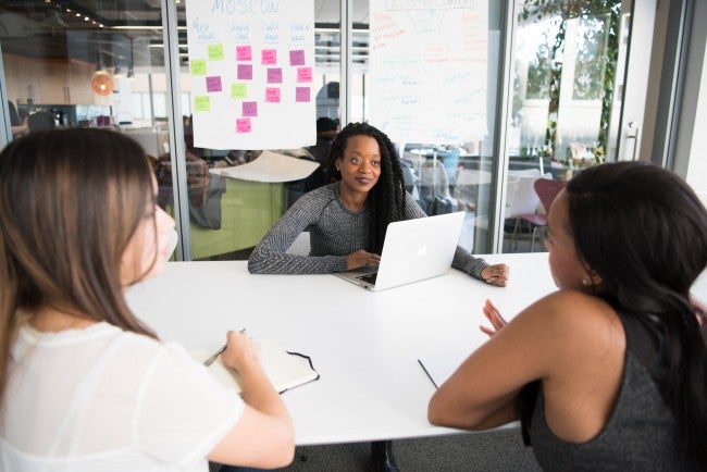 Three women in a business meeting | empathetic leadership