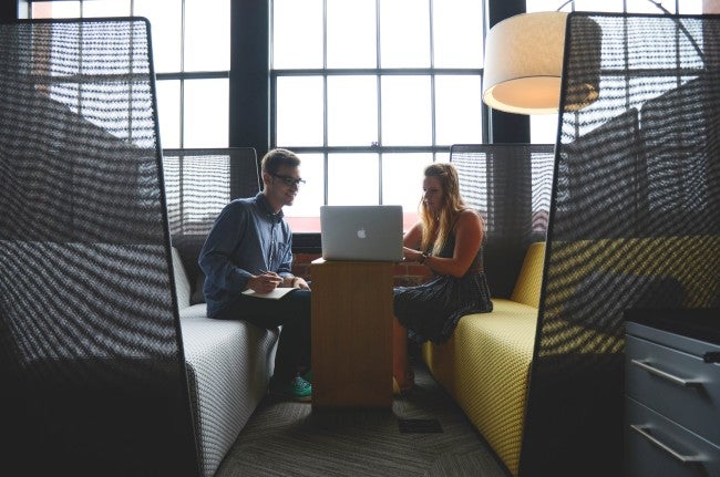 Two people looking at computer doing IT interview