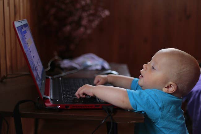 Baby playing on computer