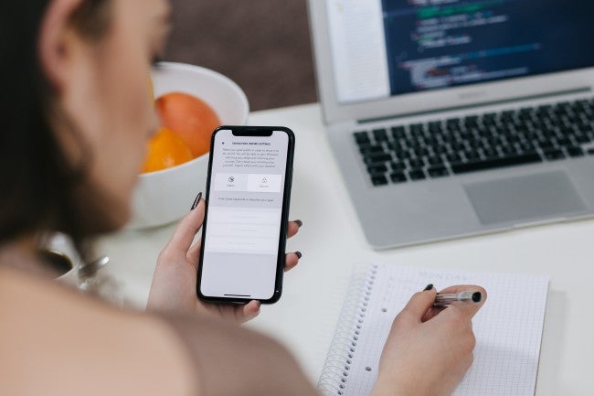 Woman looking at phone OS