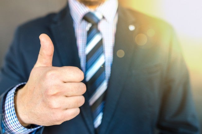 Man holding thumbs up - setting salary range