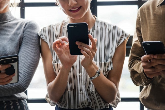 Woman holding phone for facial recognition