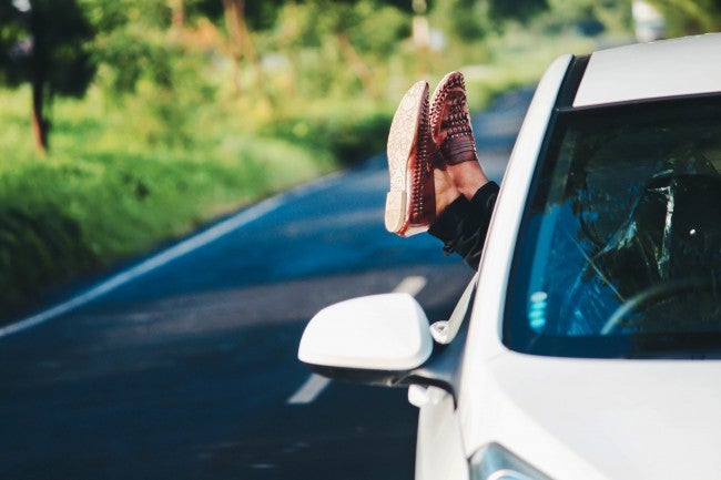 Feet out window of self driving car