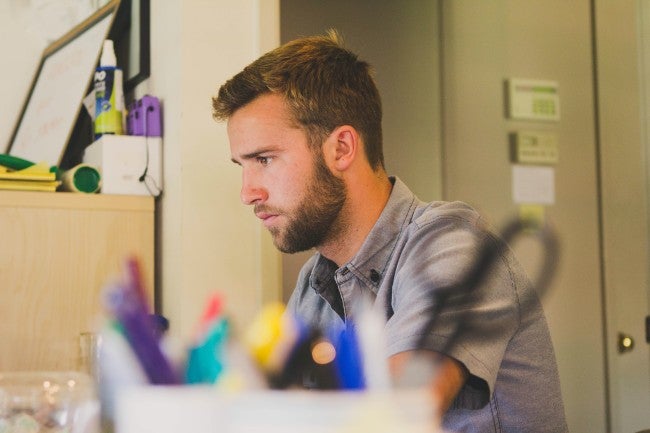 School teaching sitting at desk concentrating
