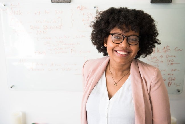 Woman teacher in front of white board