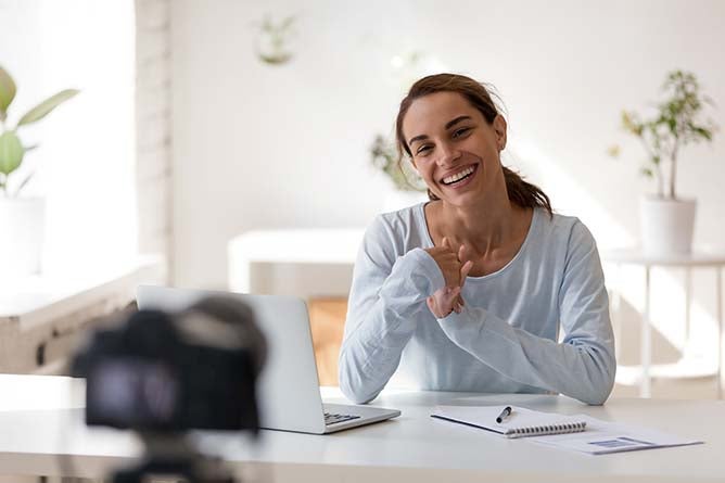 A young teacher teaches remote in her own home.